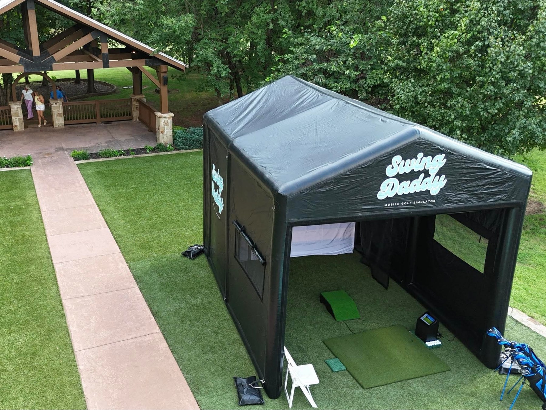 Swing Daddy branded mobile golf simulator tent set up outdoors at an Oklahoma event